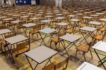 Exam tables set up in a sports hall for exams in a high school & sixth form