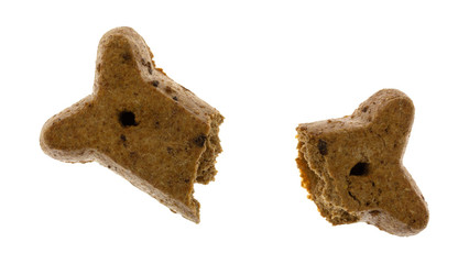 Peanut butter dog biscuit broken on a white background.