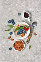 Healthy breakfast - homemade oatmeal with fresh berries and almond