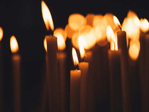 Image of many burning candles with shallow depth of field
