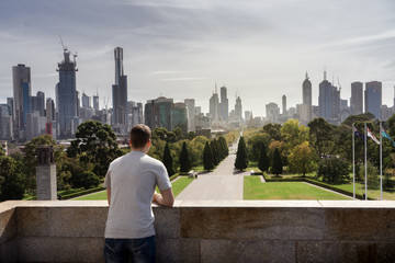 Boy looking to Melbourne City skyline Australia