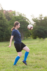 Stylish girls in a sportwear. Cute woman with ball. Girl play in soccer