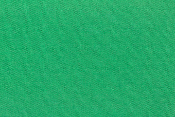 Close view of a green iron on patch for repairing torn clothing