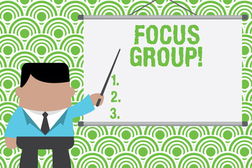 Text sign showing Focus Group. Business photo text showing assembled to participate in discussion about product Businessman standing in front projector screen pointing project idea