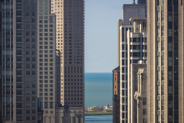 View of Lake Michigan seen from between Chicago skyscrapers. Urban sprawl vs nature.