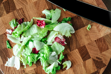 Fresh salad sliced on the board
