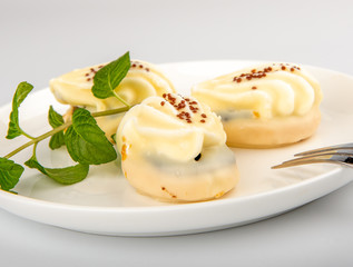 Mini yellow cakes on white background