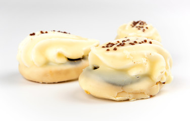 Mini yellow cakes on white background