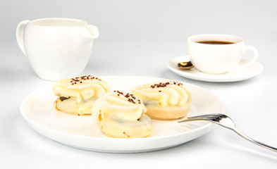 Mini yellow cakes on white background