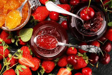 assortment of jams, seasonal berries, apricot, mint and fruits. marmalade or confiture