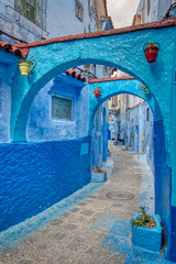 Nice alley with arches in Chefchaouen, tourist city in northern Morocco