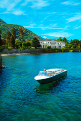 Fototapeta na wymiar Yacht on the clear turquoise water of a mountain lake