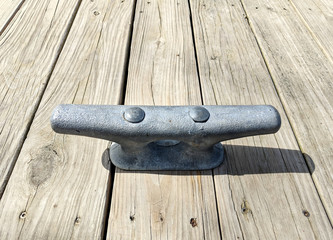 Large galvanized cleat bolted to pressure treated decking