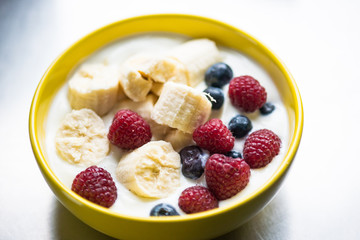 Morning breakfast set with bowl of fruits apples and blueberry.