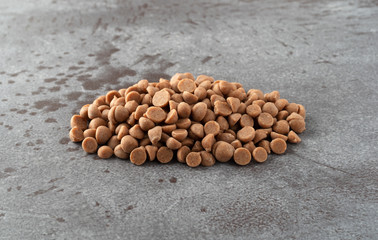 Cinnamon baking chips pile on a gray background