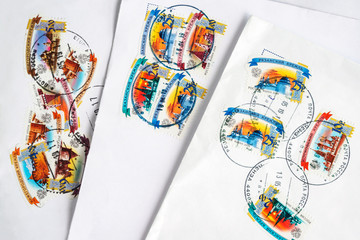 close up white envelopes with used postage stamps