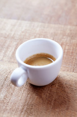 Cup of coffee on rustic wooden background. Copy space.