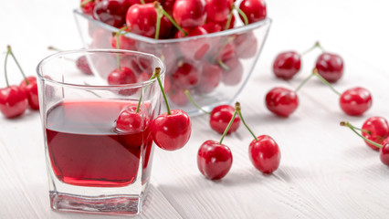 Cherry juice with glass of berries.