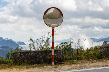 Reflections of the road on traffic mirror for traffic safety. Traffic mirror mountain road, Vietnam