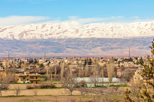 Lebanese houses in Beqaa Valley with snow cap mountains in the background, Baalbeck, Lebanon