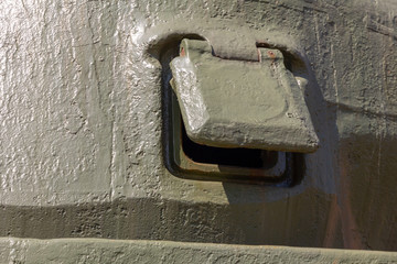 pistol loophole covered with a lid on the tower of a Sherman tank M4A2(76)W. armored embrasure Close-up