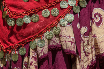 Background of draped gypsy shawls with decorative coin and bead fringe and distinctive weave for...