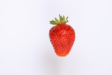 One large juicy strawberry on a white background