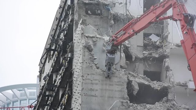 Building Wall Being Torn Down by High Reach Excavator