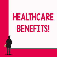 Conceptual hand writing showing Healthcare Benefits. Concept meaning monthly fair market valueprovided to Employee dependents Man stands in back view in front of huge big rectangle board