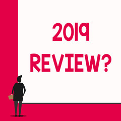 Conceptual hand writing showing 2019 Review Question. Concept meaning remembering past year events main actions or good shows Man stands in back view in front of huge big rectangle board