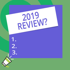 Conceptual hand writing showing 2019 Review Question. Concept meaning remembering past year events main actions or good shows Big Square rectangle stick above small megaphone left down corner