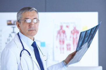 Doctor in the office examines the patient's x-ray