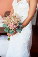 Bride holding a bouquet of flowers in a rustic style, wedding bouquet