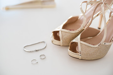 Wedding bridal shoes and accenting jewelry, earrings and bracelet.