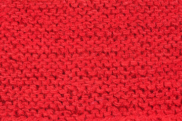 Hand knitting red background. Vintage pattern of rustic hand knitting of the middle of the last century. Red vintage wool close up background and texture
