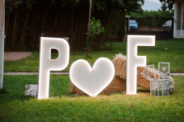 Wedding decoration of two led letters outdoors.