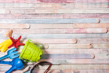 Beach toys on grunge wooden background. Holiday and vacation concept