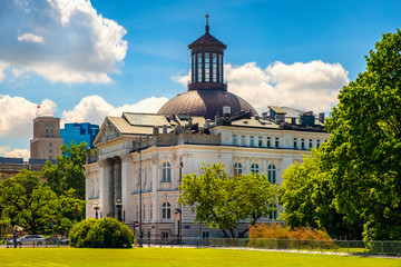 Warsaw, Poland - Zacheta Art Gallery building with Holy Trinity Evangelical Church of the Augsburg Confession in the Old Town quarter of Warsaw