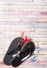 Flip-flops on grunge wooden background. Holiday and vacation concept