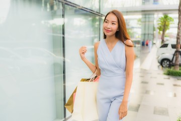 Fototapeta na wymiar Portrait beautiful young asian woman happy and smile with shopping bag from department store
