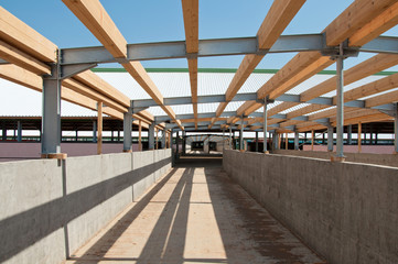 Fototapeta premium The metal frame of the building on a reinforced concrete base. The use of materials from metal and concrete in modern construction.
