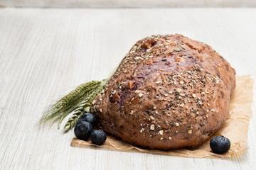 Blueberry and chia seed bloomer on white wooden table