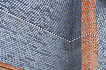 Brickwork in the construction of a new building. The use of a classic building material.