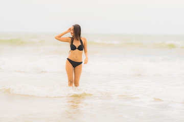 Fototapeta na wymiar Portrait beautiful young asian woman wear bikini on the beach sea ocean
