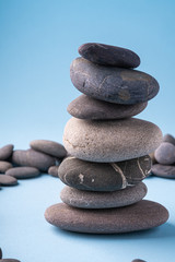 Fototapeta na wymiar Stack balance of pebbles calm therapy on blue background