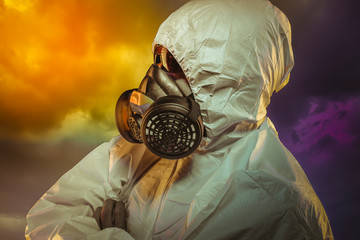 virus infection concept. Man in protective suit and antigas mask with glasses. Ebola, toxic gases, biological warfare, infections and diseases