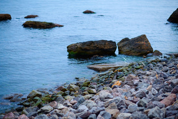 sea landscape at sunset, stone coast and beautiful sky