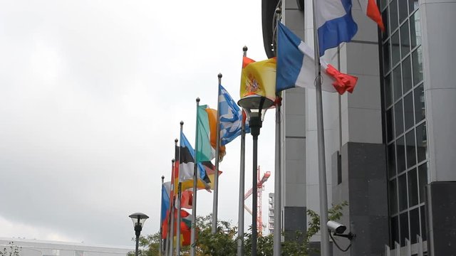 Euro symbol statue and European countries flags in front of EU Parliament