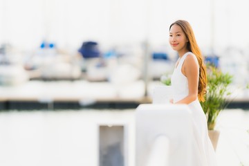Fototapeta na wymiar Portrait beautiful young asian woman leisure smile happy relax around yacht port