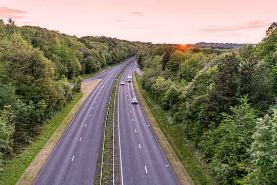 Two lane highway at sunset with cars overtaking van